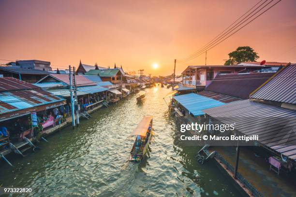 boat floating along amphawa riverside market, bangkok, thailand. - floating market stockfoto's en -beelden