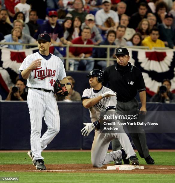 Minnesota Twins' Corey Koskie stands by as New York Yankees' Alex Rodriguez brushes himself off after stealing third base in the 11th inning of Game...
