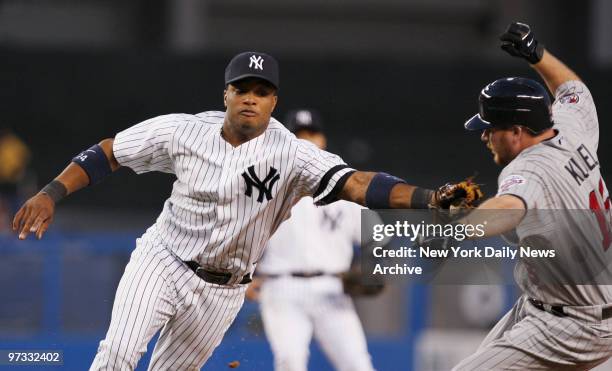 Minnesota Twins' Jason Kubel jumps clear of the tag attempt by New York Yankees' second baseman Robinson Cano during a play in the fifth inning at...