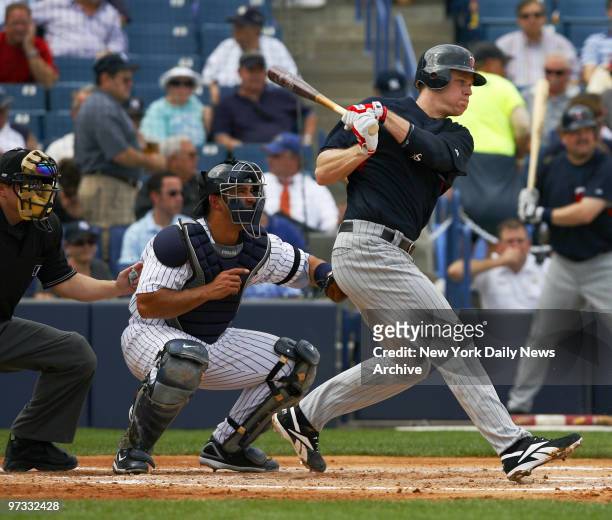 Minnesota Twins' Justin Morneau hits a grounder early in a spring training game against the New York Yankees at Legends Field.