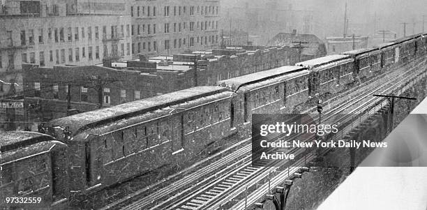 Old wooden "L" subway cars sitting on the center track of the Astoria line.