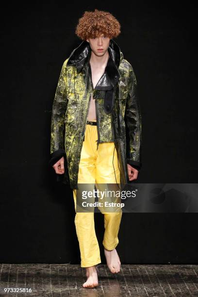 Model walks the runway at the University of Westminster MA Menswear show during London Fashion Week Men's June 2018 at the Heaven on June 11, 2018 in...