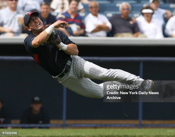 Minnesota Twins' third baseman Nick Punto attempts to make the out with a throw to first during a spring training game against the New York Yankees...