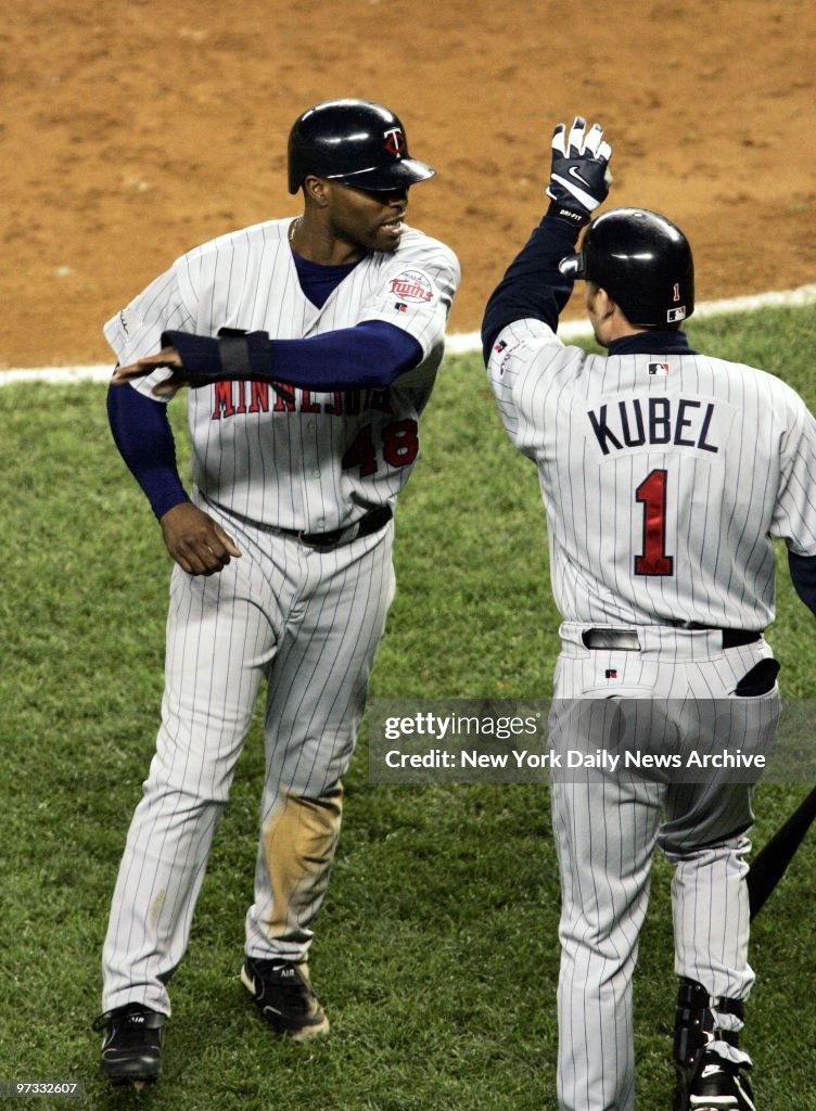 Minnesota Twins' Torii Hunter gets a high five from Jason Ku