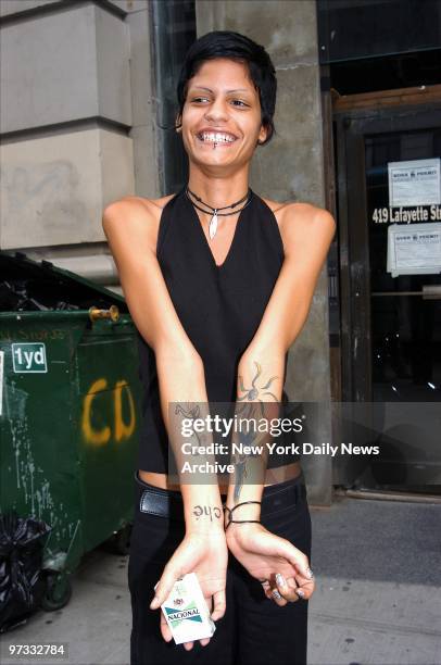 Teen model Omahyra Mota shows off her tattoos as she joins the crew of the LA Look Model Search tour bus outside Pangaea on Lafayette St. The bus is...