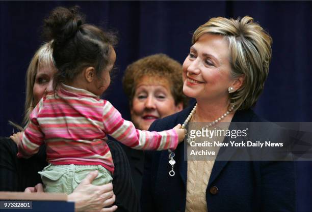 Olivia Harden tugs on Sen. Hillary Clinton's necklace during a news conference at the Ryan Chelsea-Clinton Community Heath Center on 10th Ave. Where...