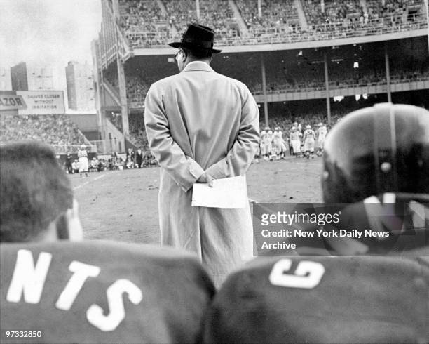 Vince Lombardi of the New York Giants' clutches a play chart during a game at Yankee Stadium.