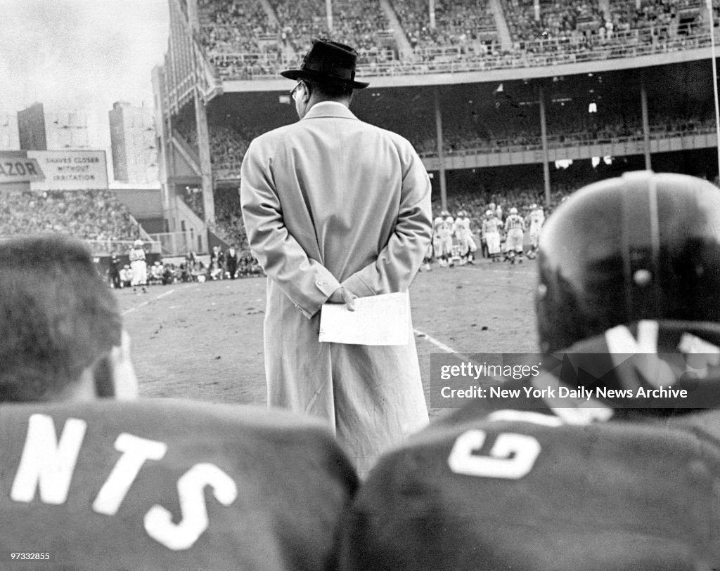 Vince Lombardi of the New York Giants' clutches a play chart