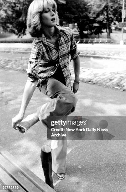 Olivia Newton-John models fall fashion for August issue of Harper's Bazaar in Central Park.