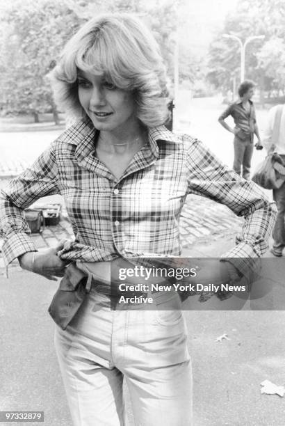 Olivia Newton-John models fashion for August issue of Harper's Bazaar in Central Park.