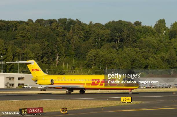 A DHL Airways McDonnell Douglas DC-9-41F taxiing crossing a runway.