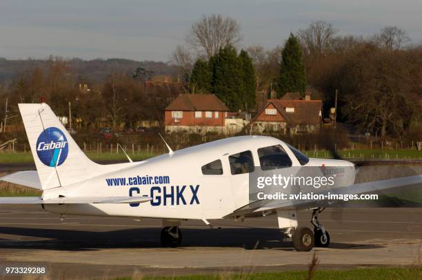 A Cabair Piper PA-28-161 Cherokee Warrior 2 taxiing with a Thielert Centurion diesel engine and trees and houses behind.