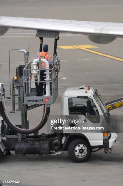 A mobile Avtur Jet-A1 fuel pump truck with refueller under the wing of a Northwest Airlines Boeing 757-200.