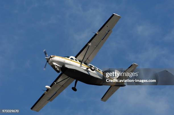 A Kenmore Air Cessna 208B Caravan with a baggage belly-pod on final-approach.