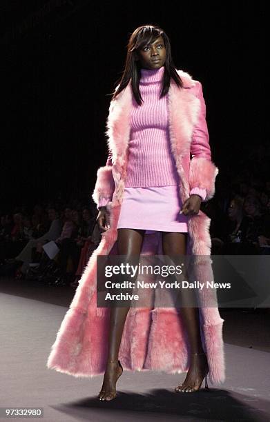 Oluchi models pink shearling separates from Luca Luca's fall collection on runway at Bryant Park during New York Fall Fashion Week 2001.