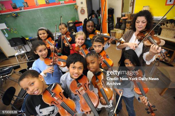 Violin instructor Roberta Guaspari who was portrayed by actress Meryl Streep in the 1999 film 'Music of the Heart.' rehearses with violin students on...