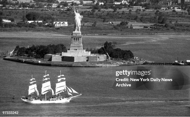 Miss Liberty Salutes her first party guest..As it sails past the statue of Liberty, Norway's full-rigged training ship Christian Radich becomes the...