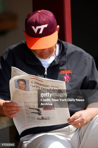 Virginia Tech baseball athletic trainer Jimmy Lawrence reads a newspaper during the team's first practice since Monday's school massacre that claimed...