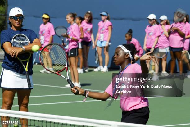Tennis pro Gigi Fernandez watches approvingly as a youngster hits a return during a Leadership Day for Girls clinic at the U.S. Open at Flushing...
