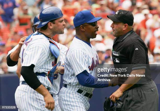 New York Mets' manager Willie Randolph gets between home plate umpire Eric Cooper and Met's catcher Mike Piazza after Cooper ejected Piazza in the...