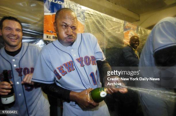 New York Mets' manager Willie Randolph pops the cork and sprays his players with champagne in the locker room at Dodger Stadium after the Mets beat...