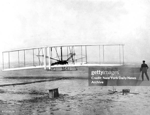 On Dec. 17 the hour is approximately 10:37 a.m. And Orville Wright, stretched out face-down on the lower wing panel of the Wright brothers' Kitty...