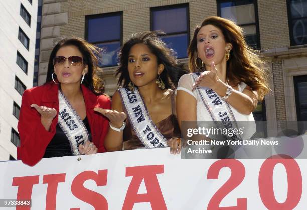 Miss USA contestants Brenna Kathleen Sakas of Arizona, Adriana Diaz of New York and Jessica Boyington of New Jersey blow kisses from atop a double...