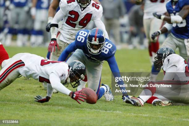 The Atlanta Falcons' Kevin Mathis pounces on a fumble by New York Giants' Ron Dixon late in the fourth quarter at Giants Stadium. The Falcons went on...