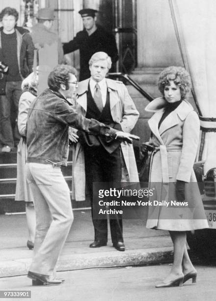 Director Sidney Pollack directs Robert Redford and Barbra Streisand at the Plaza Hotel during filming of "The Way We Were."
