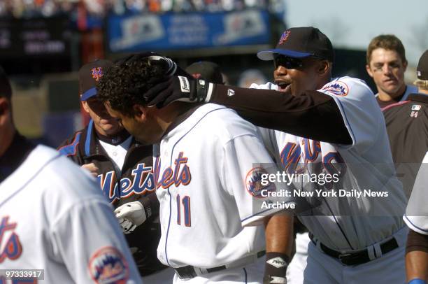 New York Mets' outfielder Cliff Floyd jubilantly congratulates catcher Ramon Castro on his game-winning single during the ninth inning of game...