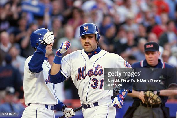 New York Mets' Mike Piazza gets congratulated by teammate Robin Ventura after hitting a solo homer in the first inning against the Baltimore Orioles....