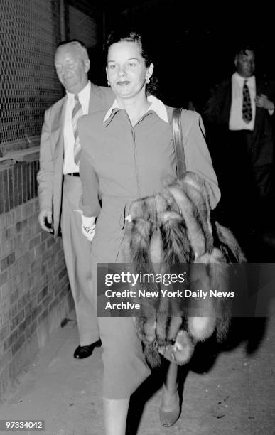 On way to Miami, Virginia Hill, girl friend of the slain gambler Bugsy Siegel, walks from plane at Laguardia Field last night.