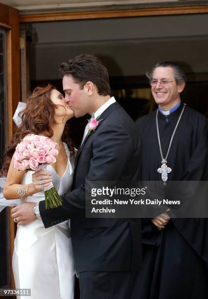 New York Mets' Mike Piazza kisses his bride, Alicia Rickter, as they leave St. Jude's Catholic Church in Miami after their wedding ceremony.
