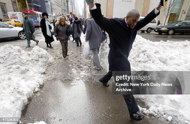 One pedestrian at least, manages to look graceful crossing a small lake created by melting snow at the corner of Fifth Ave. And 57th St. Two days...