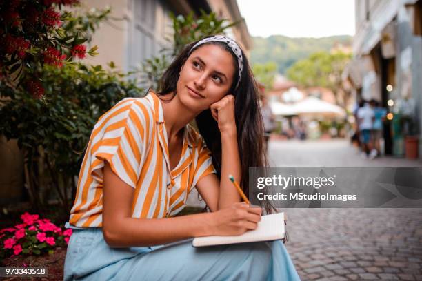 smiling student taking a break - travel writer stock pictures, royalty-free photos & images