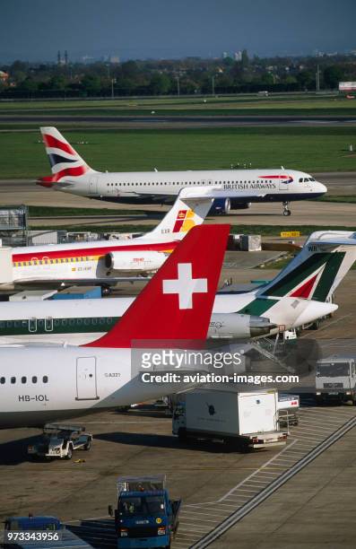 An international mix of tail-fins of Swiss International Airlines Airbus A321-200, Alitalia and Iberia McDonnell Douglas MD-80s with a British...