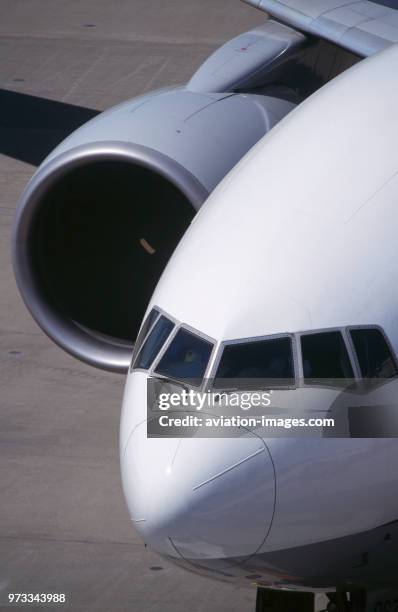 Windshield and PW4084 engine intake of ANA Boeing 777-200 parked.