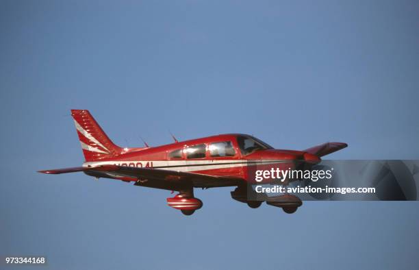 Red Piper PA-28 Cherokee flying enroute.