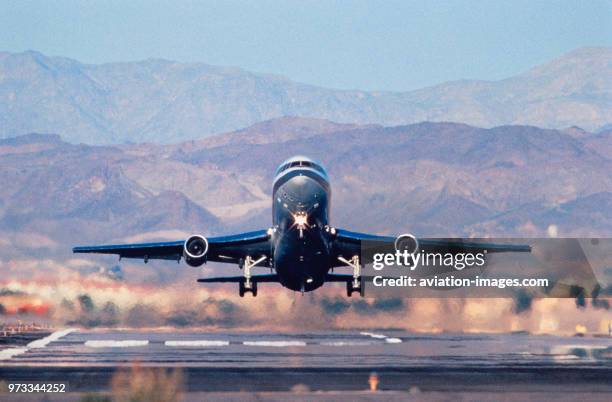 Lockheed L-1011 Tristar taking-off with mountains behind.