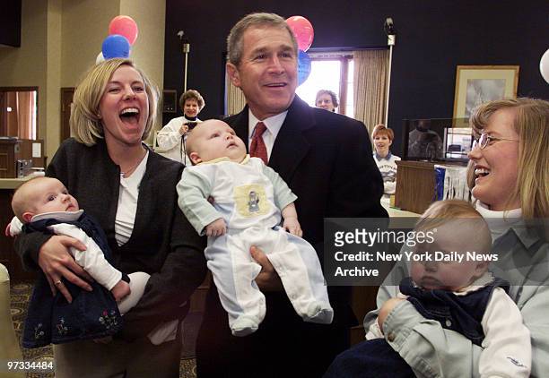 Texas Gov. George W. Bush meets babies and their mothers at a local bank during a walking tour through Glenmont, Iowa Friday morning.
