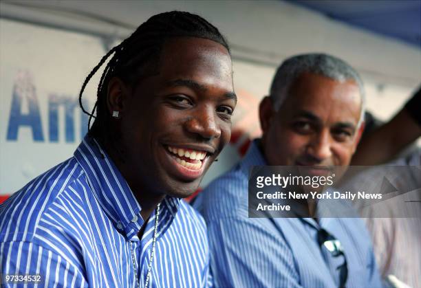 New York Mets' outfielder Lastings Milledge , who was sent down to Triple-A Norfolk today, talks with general manager Omar Minaya in the dugout...