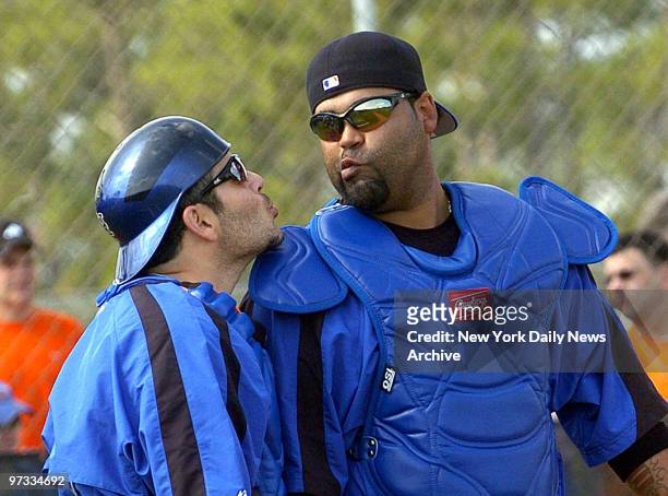 New York Mets' Paul Lo Duca and Ramon Castro pucker up as they ham it up for the photographers during spring training at Tradition Field.