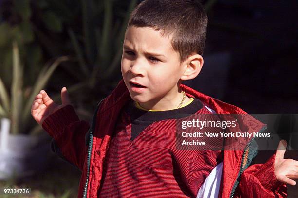 Elian Gonzalez plays in the yard of his Miami home on day after his meeting with his two grandmothers, who journeyed from Cuba in hope of bring the...