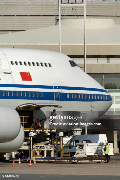 Parked at Terminal1 with front lower cargo door open and Chinese flag on the fuselage.