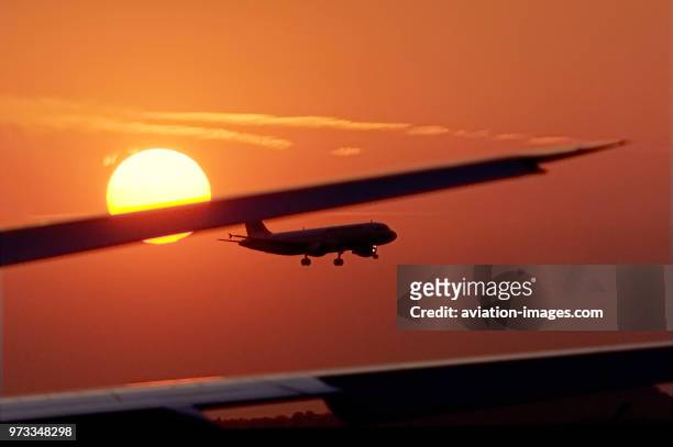 Landing at sunset past the horizontal-stabiliser of an A330 at sunset.