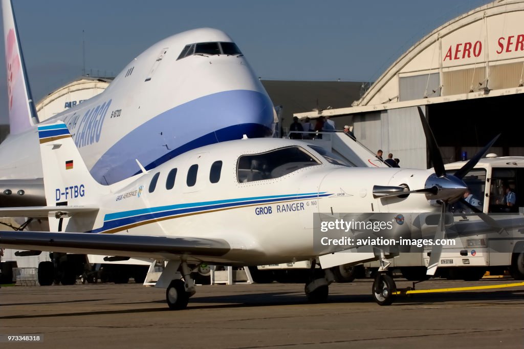 Grob Ranger being towed into the static-display past a Boeing 747-409F at the 2005 Paris AirShow