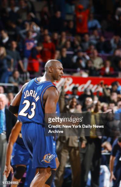 Washington Wizards' Michael Jordan exults as he makes the game-winning basket past the New York Knicks' Allan Houston and Latrell Sprewell with 3.2...