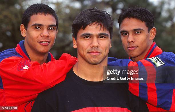 Che Cockatoo-Collins of Essendon Bombers poses with his brothers Donald and David of the Melbourne Demons during a portrait session , 1996 in...
