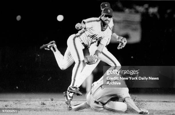 Wally Backman of the New York Mets makes a double play against the Montreal Expos.