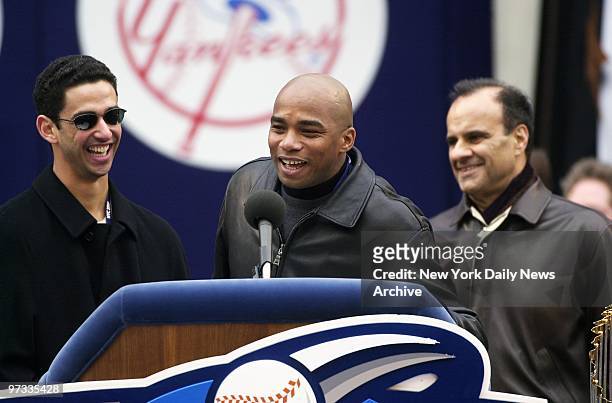Orlando Hernandez speaks to the crowd as Jorge Posada and manager Joe Torre look on during ceremony at City Hall after ticker tape parade held to...